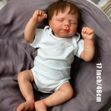 Adorable KEIUMI reborn doll sleeping peacefully, showing delicate facial features.
