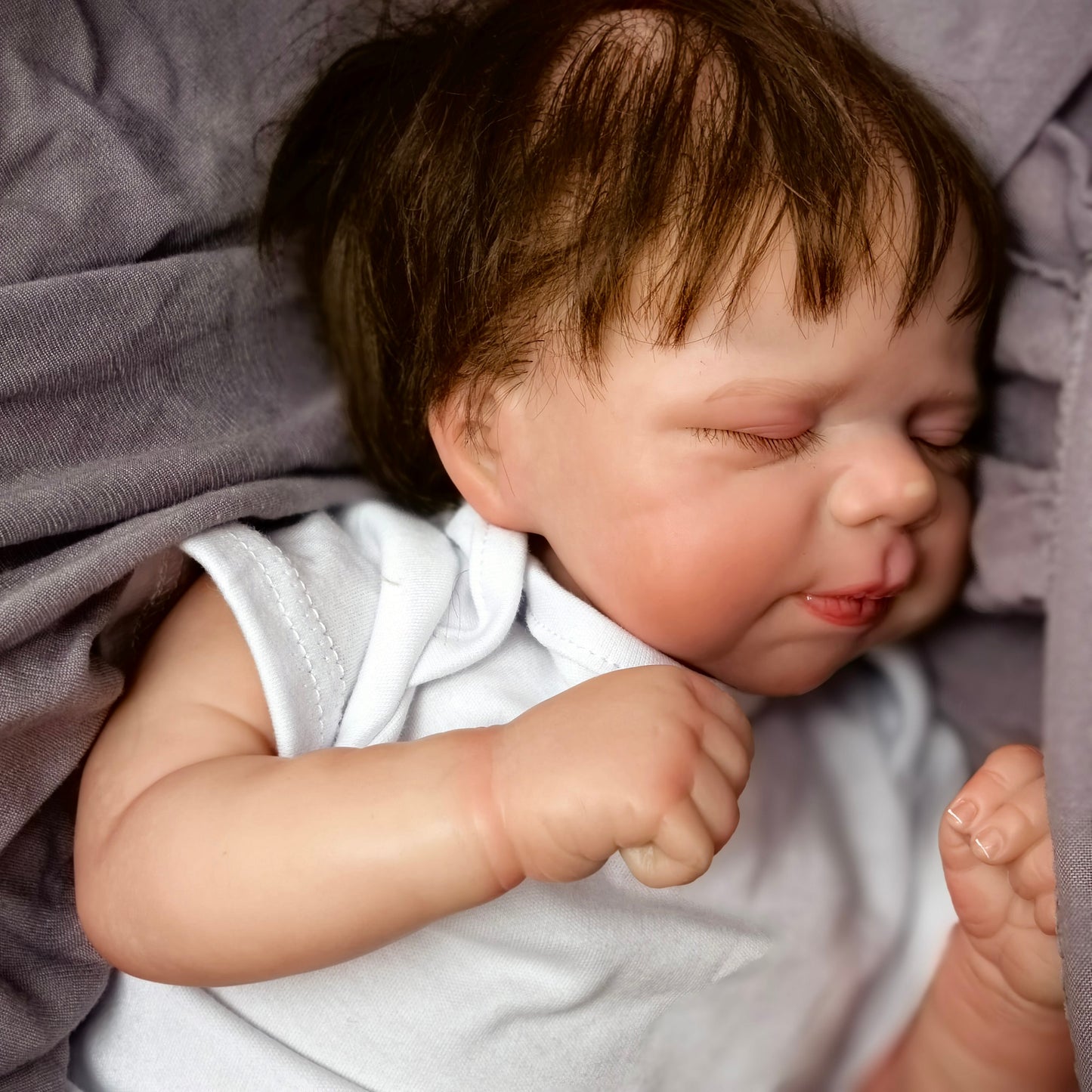KEIUMI newborn reborn doll nestled on a soft blanket, perfect for cuddles.