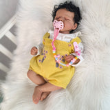 KEIUMI reborn doll showcasing its cozy knitted outfit and realistic features.