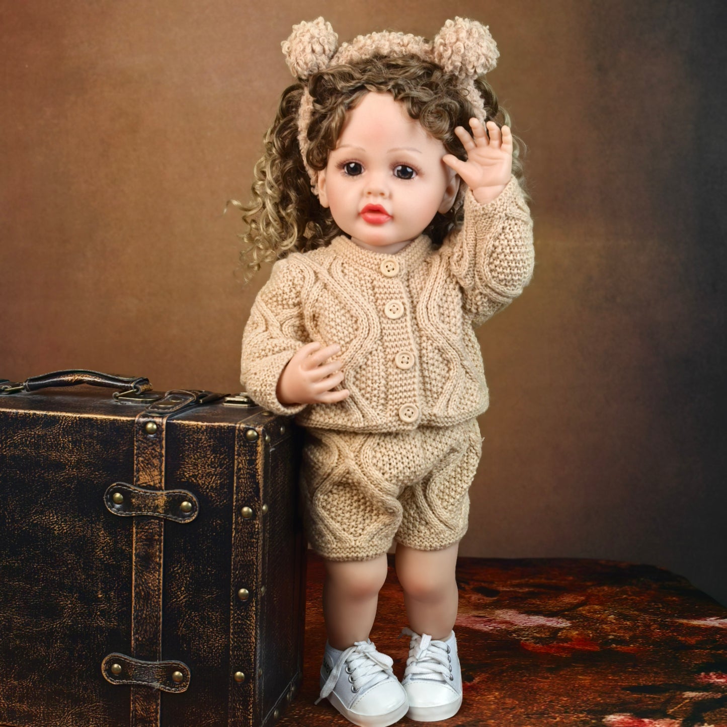 KEIUMI Clover toddler reborn doll sitting, showing full knitted outfit.