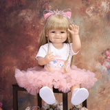 Side profile of smiling blonde reborn doll wearing glitter cat ear headband.