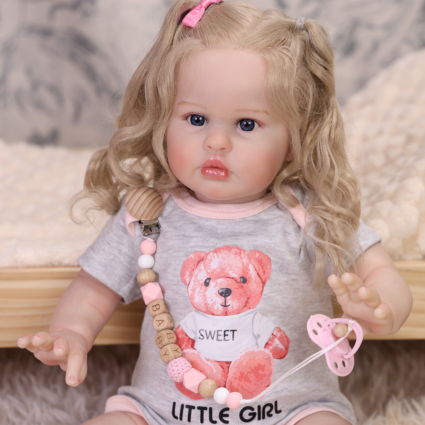 KEIUMI Penny reborn doll with blonde pigtails, blue eyes, and sweet pout expression.