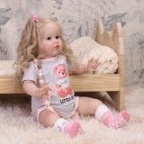 Close-up of Penny reborn doll's face, showing her realistic blue eyes and fair skin.