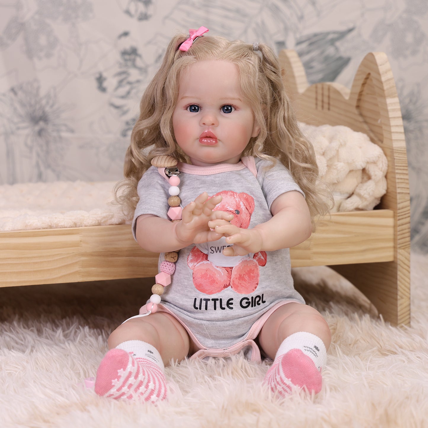 Full view of Penny reborn doll with all accessories, including bottle and teddy.