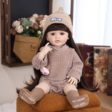 KEIUMI Wonder Toddler reborn doll with brown eyes, wearing a knitted brown romper.