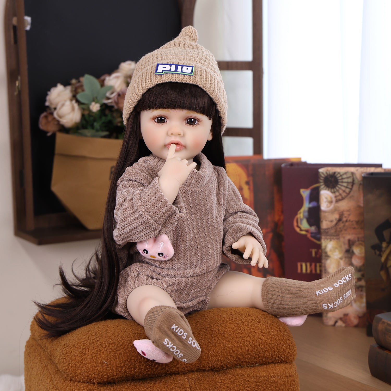 Close-up of KEIUMI reborn doll's face, showing curious brown eyes and open mouth.
