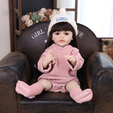 Elara reborn doll holding her clear baby bottle with a pink cap.