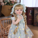 Reborn toddler doll in full daisy outfit, showing ruffled sleeves and sandals.
