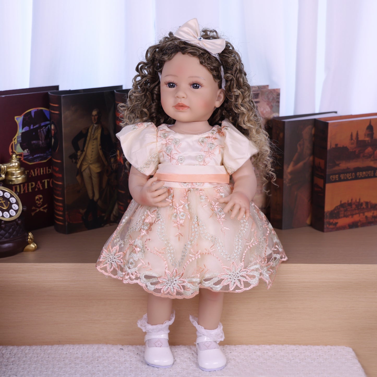 Side profile of Emmeline reborn doll, highlighting her curly hair and pensive expression.