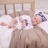 Close-up of the lifelike sleeping face of the KEIUMI Dreamer reborn doll.
