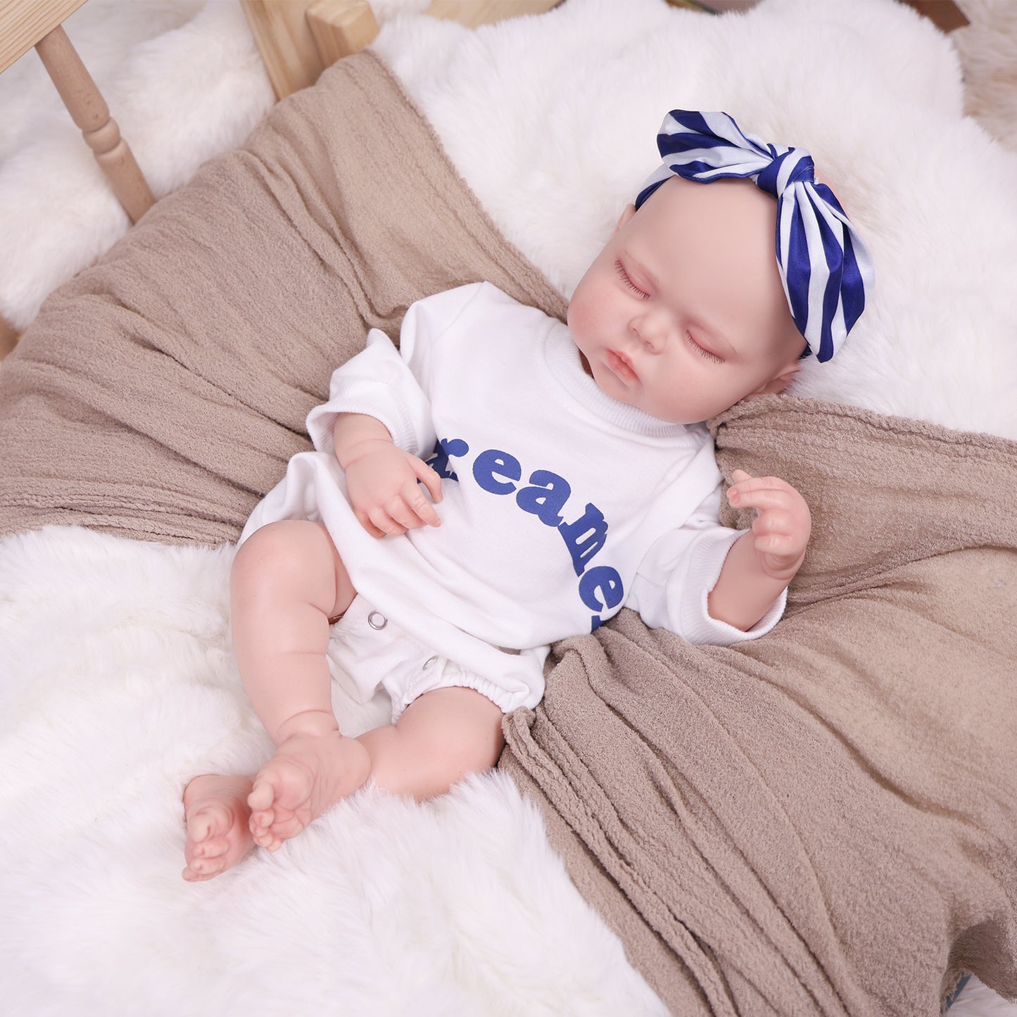 Side profile of the sleeping reborn doll, showing its gentle facial features.