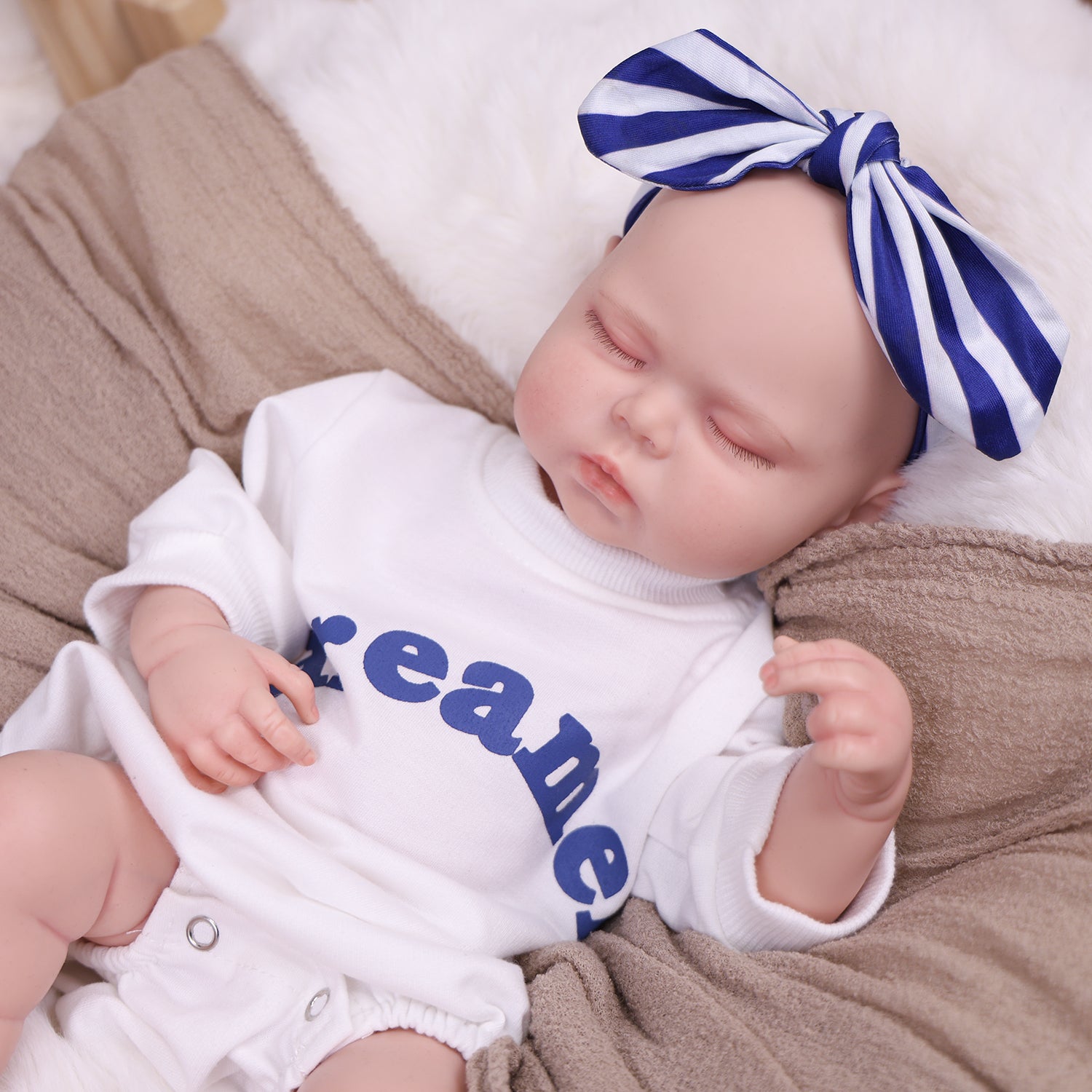 The reborn doll's foot, with realistic wrinkles and baby toes.