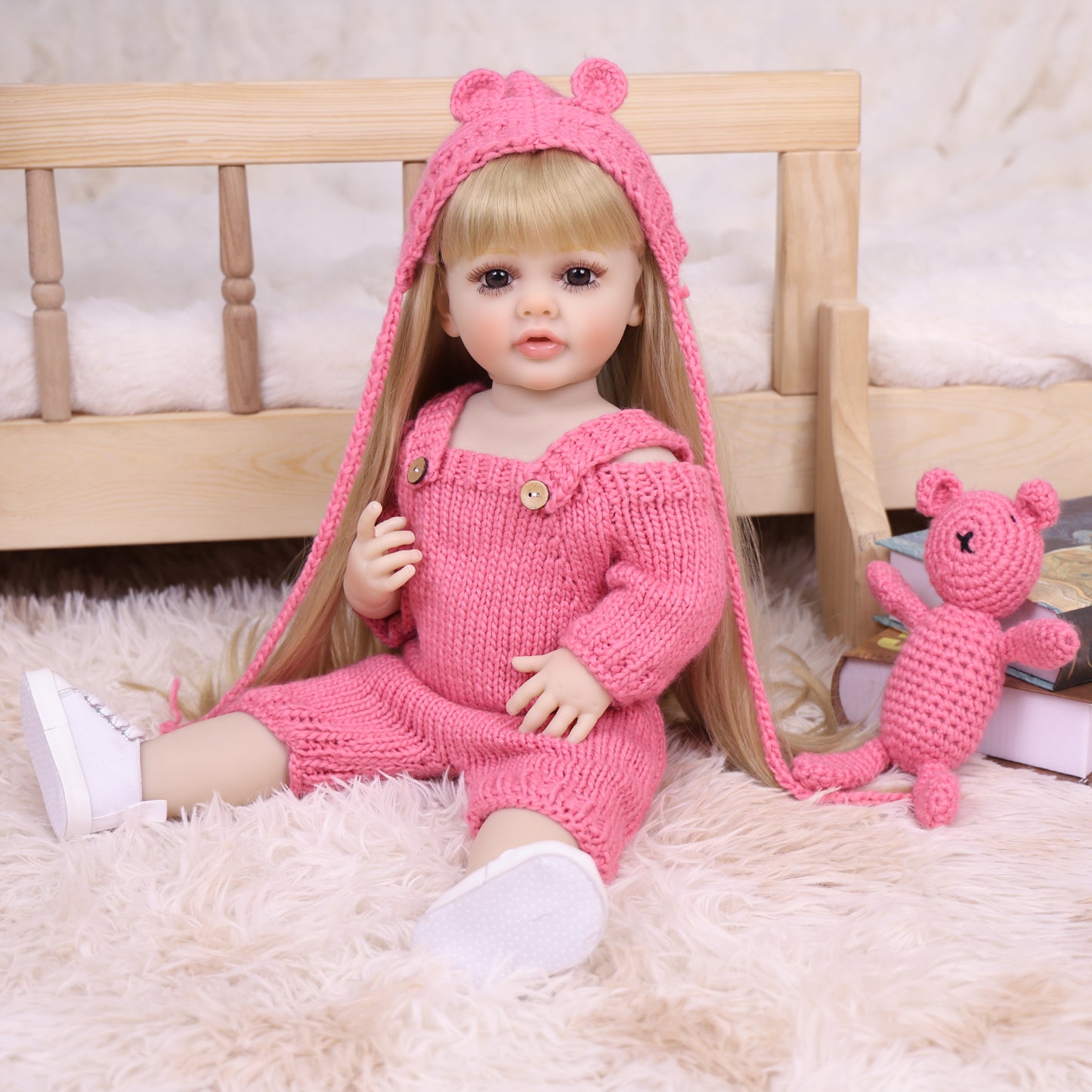 Close-up of Maisie reborn doll's face with blonde hair and gentle expression.