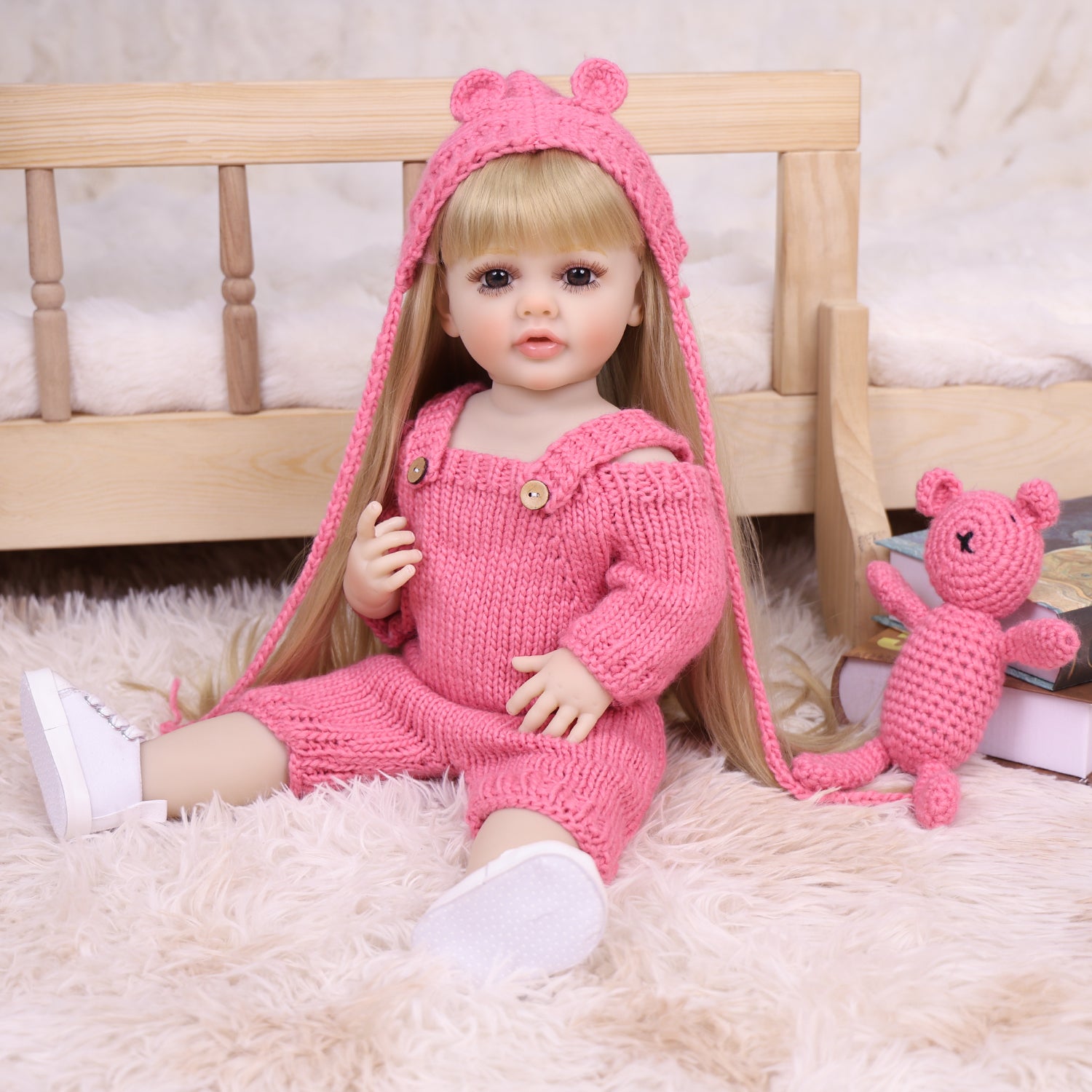 Close-up of Maisie reborn doll's face with blonde hair and gentle expression.