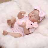 Sleeping reborn doll's face, highlighting rosy cheeks and delicate features.
