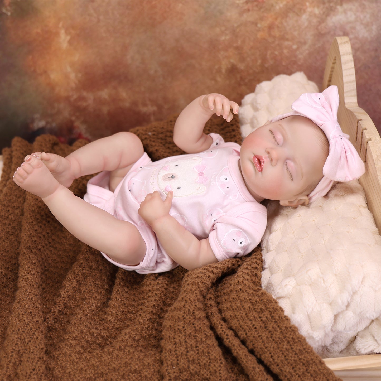 Sleeping reborn doll with her plush bunny toy, perfect for cuddling.