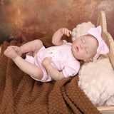 Sleeping reborn doll with her plush bunny toy, perfect for cuddling.