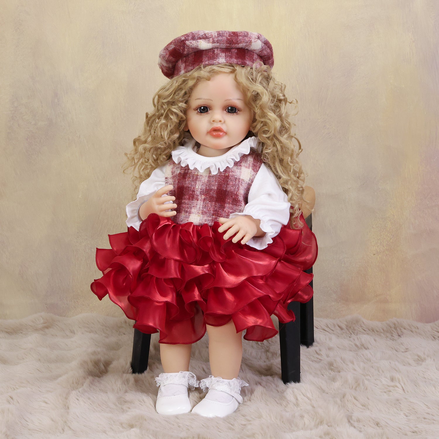 KEIUMI Curious Belle reborn doll in plaid dress, showing her golden curls.