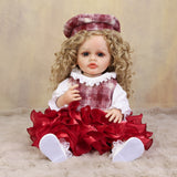 KEIUMI Curious Belle doll wearing her red and white plaid beret and holding bottle.