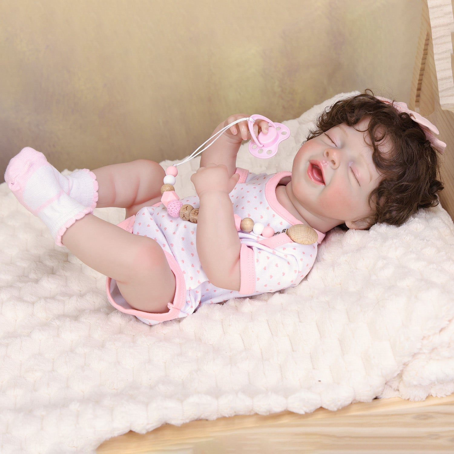 Rosalie silicone reborn baby doll sleeping peacefully, gentle smile, pink pacifier.