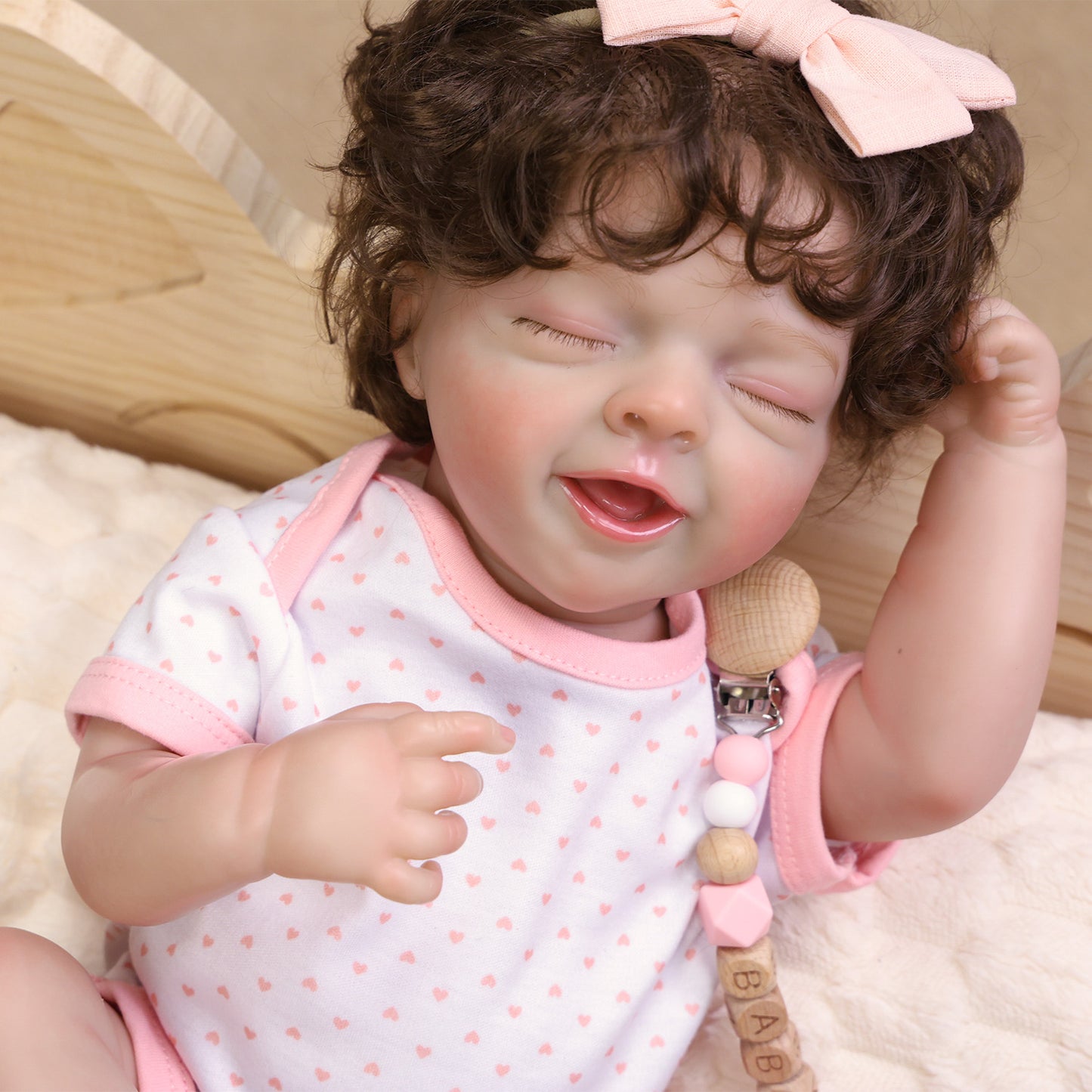 Rosalie's delicate hand holding the pink pacifier, showing realistic skin folds.
