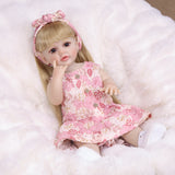 KEIUMI Posy reborn doll with blonde hair and pink floral dress.