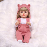 KEIUMI Blossom reborn doll in pink knitted outfit, front view.