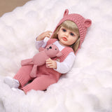 Close-up of Blossom reborn doll's expressive blue eyes and blonde hair.