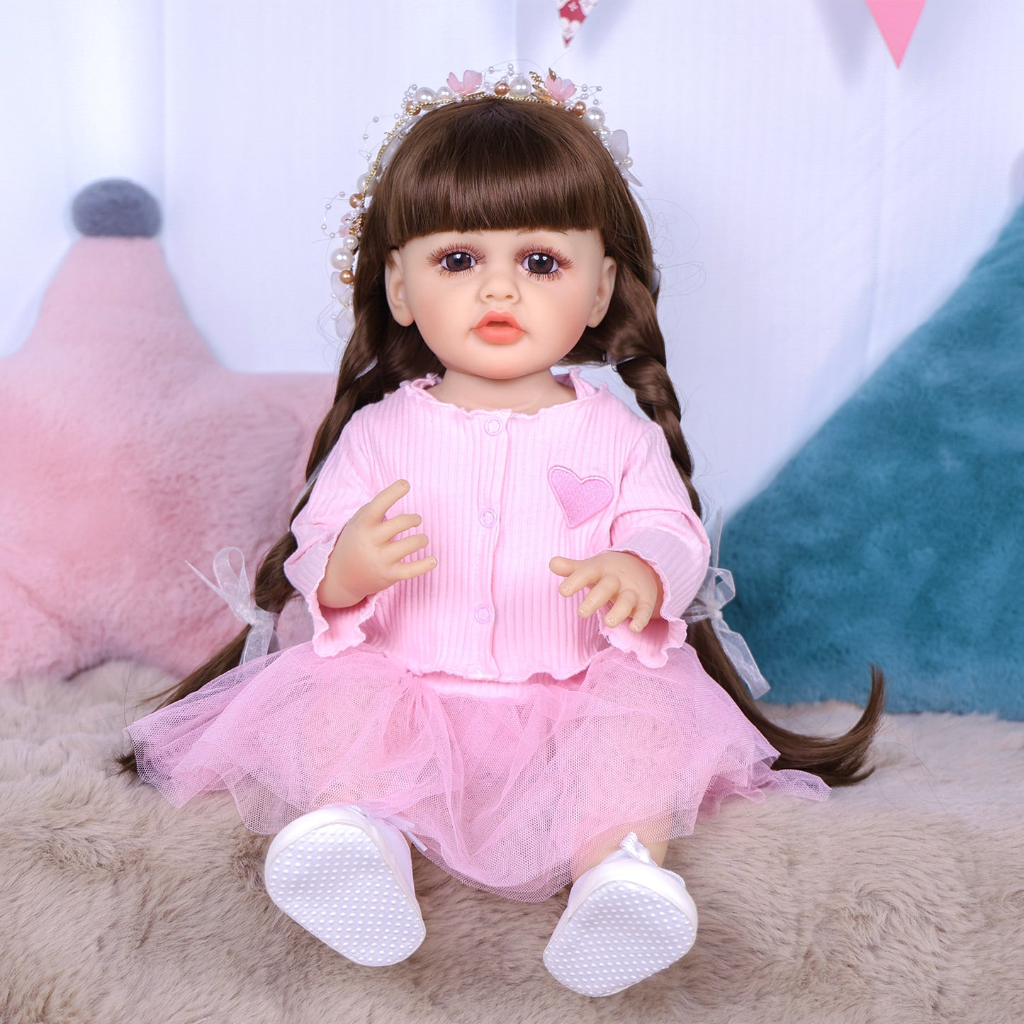 Close-up of Lily reborn doll's face, showing pouty lips and dark brown hair.