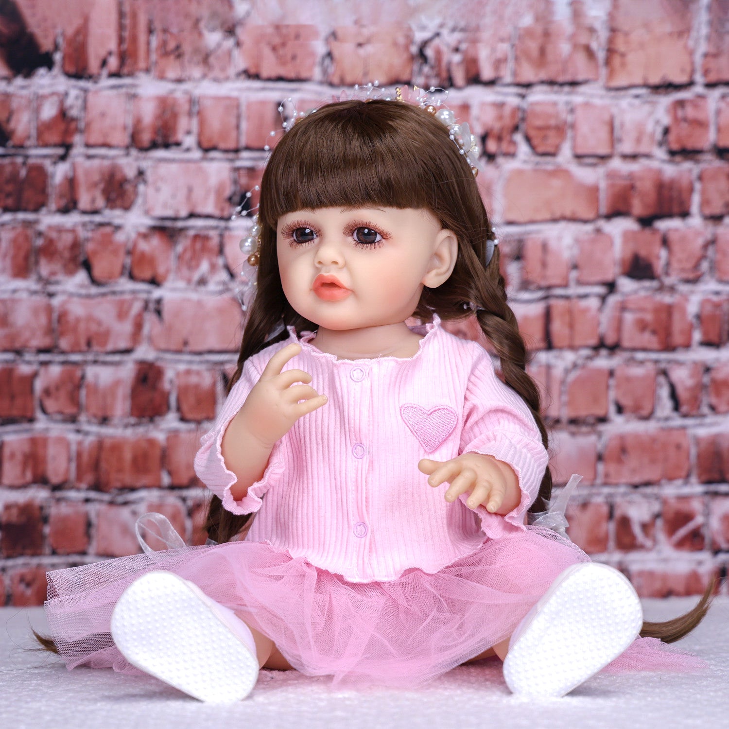 Side profile of Lily reborn doll, highlighting her long dark brown hair.