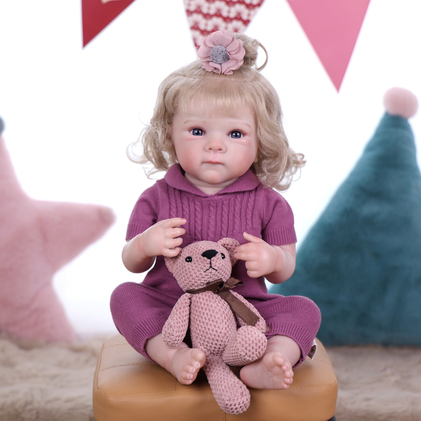 Full view of KEIUMI Willow reborn doll in her cozy plum knitted romper.