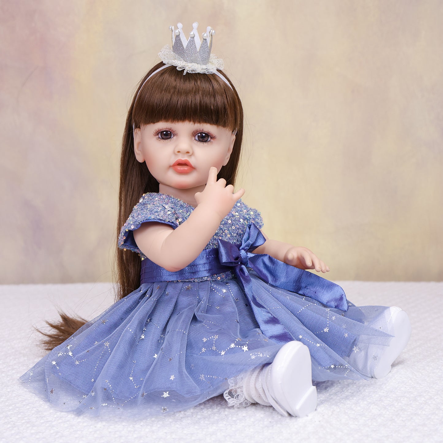 Side profile of Aurora reborn doll showing her long brown hair and blue gown.