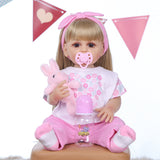 Close-up of Joy reborn doll's sweet face, brown eyes, and blonde hair.