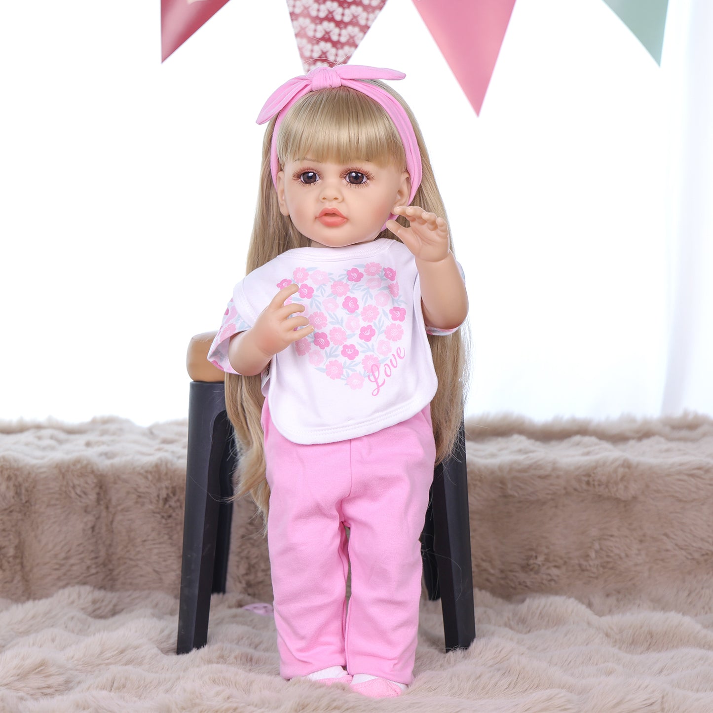 KEIUMI Joy doll's feet in white socks with pink accents, holding pacifier.