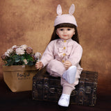 Close-up of Poppy reborn doll's sweet face, dark brown eyes.