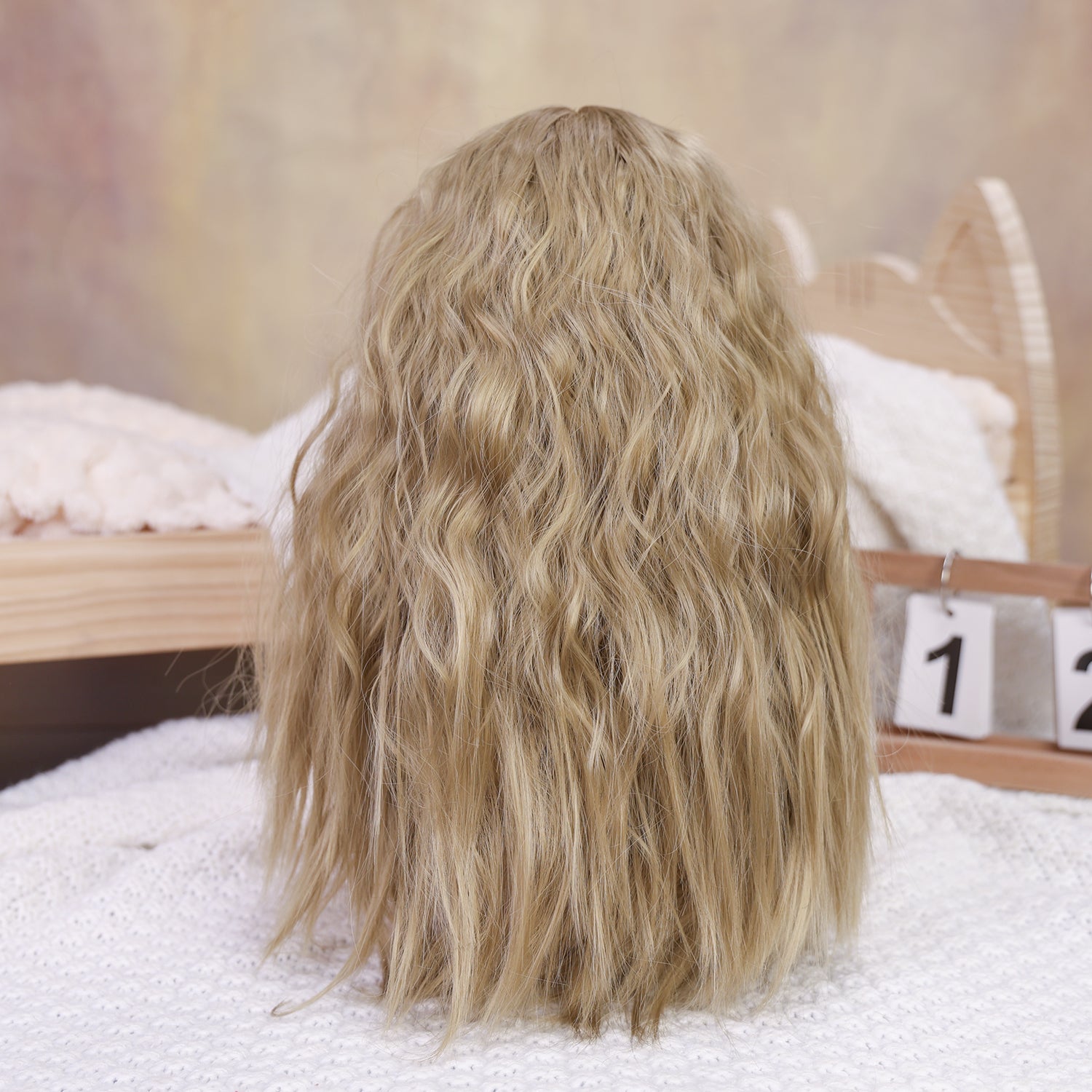 KEIUMI Peaches reborn toddler doll with long blonde hair and blue eyes.