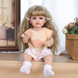 Peaches reborn doll with baby bottle, highlighting her lifelike soft touch vinyl skin.