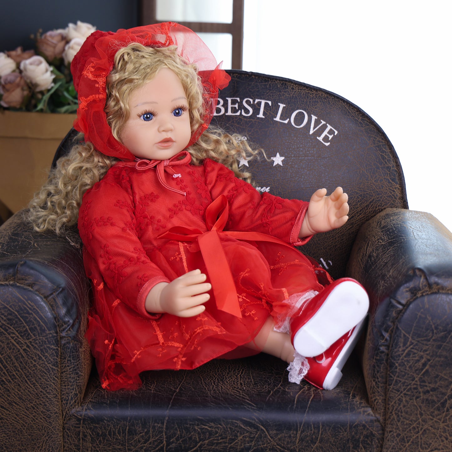 Close-up of Ruby Belle doll's face, showing bright blue eyes and neutral expression.