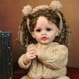 Close-up of KEIUMI Clover doll's curious face, curly hair, and brown eyes.