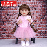 Lily reborn doll with dark blue eyes and sweet expression, wearing a pink outfit.