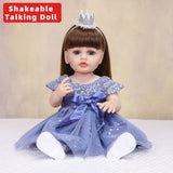 Aurora reborn doll with brown hair in a blue princess gown, looking forward.